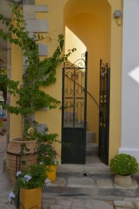 an entrance to a building with two black doors at Myrtia in Symi