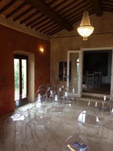 a room with a table and chairs and a chandelier at Casatorta in Vicchio