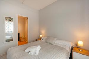 1 dormitorio con 1 cama con 2 toallas en Penthouse Apartment, en Barcelona