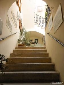 a set of stairs in a building with a plant at Palazzo Antica Via Appia in Bitonto