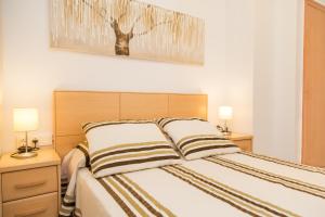Posteľ alebo postele v izbe v ubytovaní Los Olivos Apartment Cullera + 37 fotografií