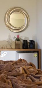a bedroom with a large mirror on the wall at Dome Rooms Downtown in Chania Town +67 photos