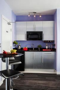 a kitchen with a stove top oven and a microwave at M Boutique Hotel in Miami Beach