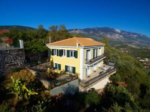 a large white house on top of a hill at The Edge Villa - 2024 Renovated in Argostoli