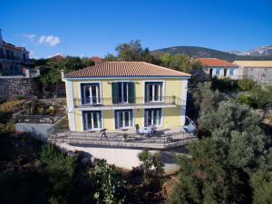 a large yellow house with a roof at The Edge Villa - 2024 Renovated in Argostoli