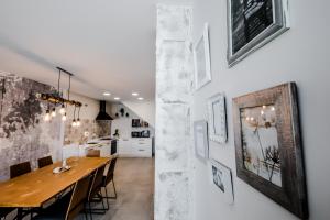 a kitchen and dining room with a wooden table and chairs at Casa Rural Peña Gamella in Herreros