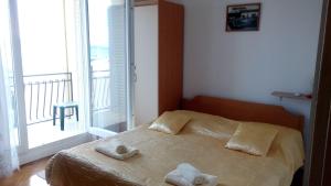 Postel nebo postele na pokoji v ubytování Apartments Pilić