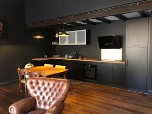 a kitchen with a table and a kitchen with a counter at Le Logis d'Augustin in Mont-de-Marsan