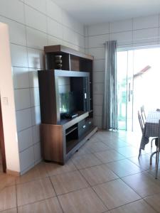 a living room with a television in a cabinet at Apartamentos de Penha in Penha