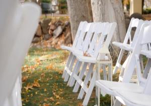 a row of white chairs sitting next to a tree at Los Abrigados Resort and Spa in Sedona