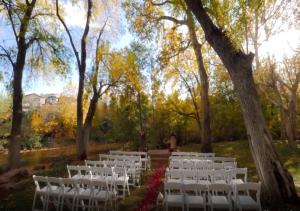 an aisle of white chairs in a park with trees at Los Abrigados Resort and Spa in Sedona