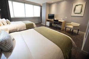 Rúm í herbergi á Unipark by Oro Verde Hotels