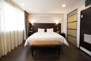 Rúm í herbergi á Unipark by Oro Verde Hotels