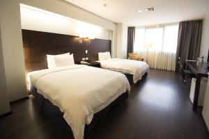 Rúm í herbergi á Unipark by Oro Verde Hotels