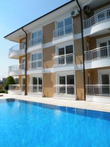 un edificio con piscina frente a un edificio en Antalya belek sama river golf apart second floor 2 bedrooms pool view close to center, en Belek