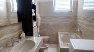 a bathroom with a sink and a toilet at Apartments Pilić in Šibenik