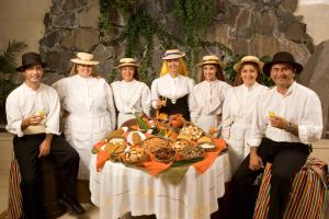 a group of people standing around a table with food at Hotel Gran Rey in Valle Gran Rey