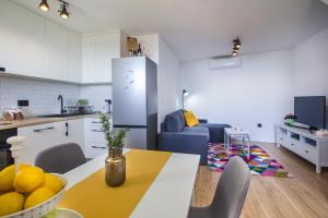 a kitchen and living room with a table and chairs at Holiday House Kleme in Makarska