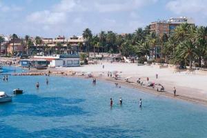 a group of people in the water at a beach at Casa Luna in Santiago de la Ribera