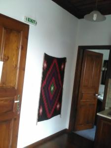 a rug hanging on a wall next to a door at Vera's Traditional House in Zagora