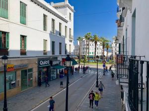 a group of people walking down a city street at MARHABA INN by HB Hostels in Tetouan