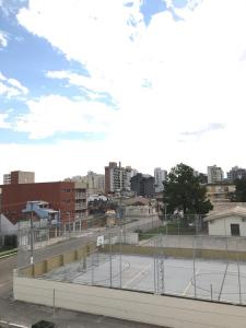 an empty parking lot with a city in the background at Pousada Tchê Aprochega in Pelotas +13 photos