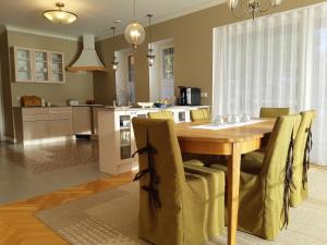 a kitchen with a wooden table and some chairs at Savimäe puhkemaja in MikitamÃ¤e