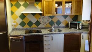 a kitchen with a sink and a counter top at La Casita de Cayetana in Piedrahita