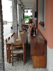 a table and chairs in a restaurant with a counter at albergovalbella in Rossa