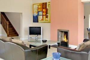a living room with a couch and a fireplace at Westport, Co. Mayo - Sleeps 10, Pool Table, ideal holiday base in Westport