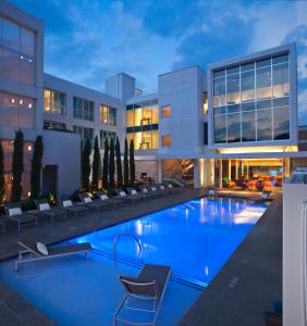 a large swimming pool in front of a building at The Lumen in Dallas