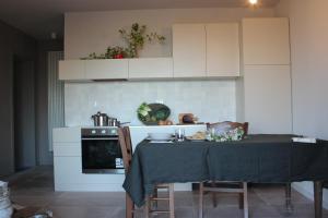 a kitchen with a table with a table cloth on it at Agriturismo Qui e Ora in Bevagna