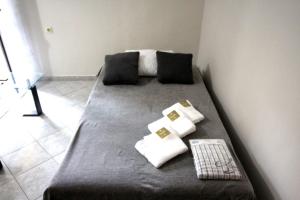 a bed with pillows and a keyboard in a room at Dimitris Flat in Neoi Epivates