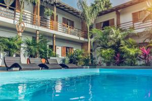 a hotel with a swimming pool in front of a building at Villa Eden Palomino in Palomino