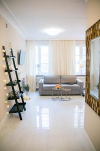 a living room with a couch and a table at Rycerska - Stone Steps Apartments in Warsaw