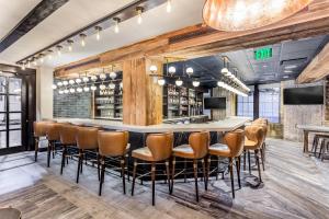 a bar in a restaurant with chairs and a bar counter at The Mercantile Hotel in New Orleans