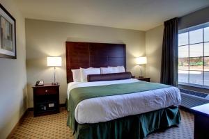A bed or beds in a room at Cobblestone Hotel & Suites - Newton