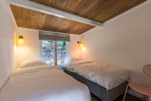 Ένα ή περισσότερα κρεβάτια σε δωμάτιο στο George's Lodges Renesse