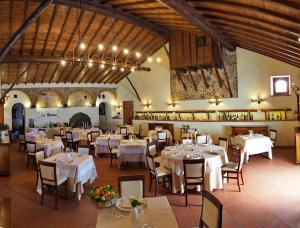 a dining room with white tables and chairs at Il Borgo Country Resort in Castiglione di Sicilia