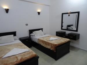 A bed or beds in a room at Nile Sunrise Flats