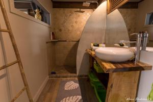 a bathroom with a sink and a shower at Fare Matatia in Punaauia