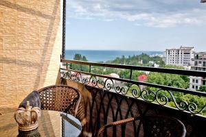 a bench on a balcony with a view of the city at Beach & Beatles Apartments in Odesa