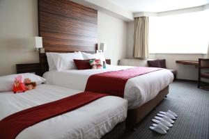 Postel nebo postele na pokoji v ubytování Jinglun Hotel Beijing