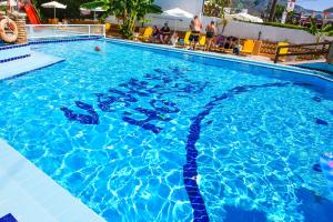 a swimming pool with blue water in a hotel at Vanessa Hotel in Kalamaki