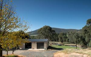 a small building with a garage in a field at Pound Creek Gallery in Tumbarumba +21 photos