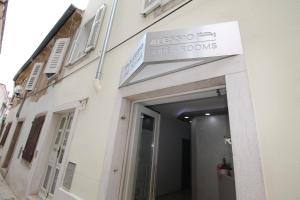 a entrance to a building with a sign above a door at Sette Stanze in Poreč