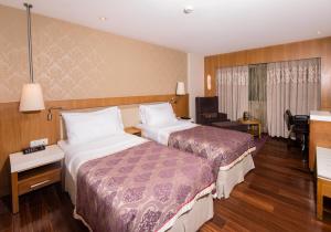 Postel nebo postele na pokoji v ubytování Hotel Bawa International