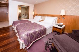 Postel nebo postele na pokoji v ubytování Hotel Bawa International
