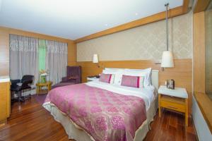 Postel nebo postele na pokoji v ubytování Hotel Bawa International