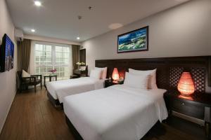 מיטה או מיטות בחדר ב-Azure Sapa Hotel